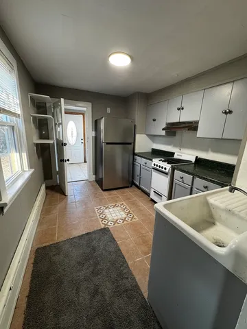a kitchen with refrigerator and window