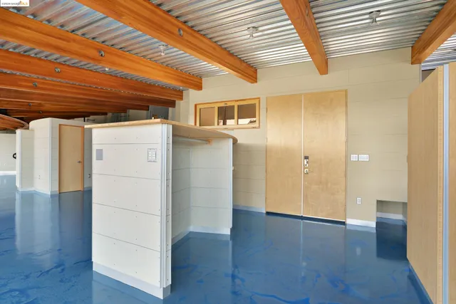 a view of a kitchen with wooden floor and chair