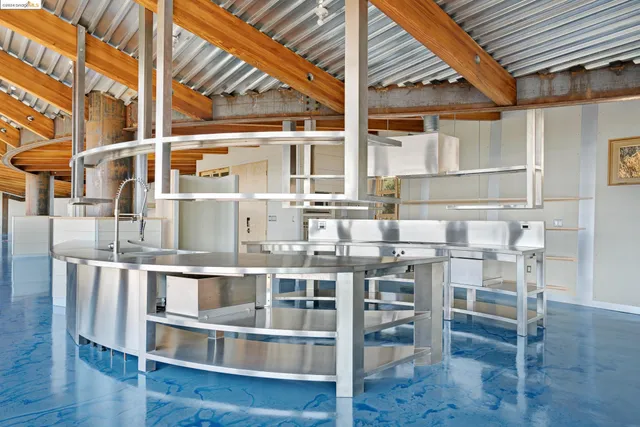 a roof deck with couch and chairs