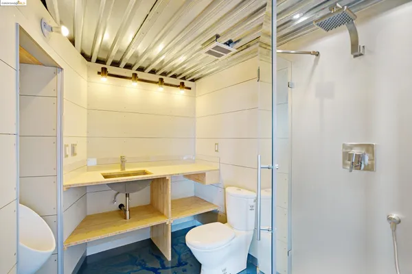 a kitchen with a sink a stove and white cabinets