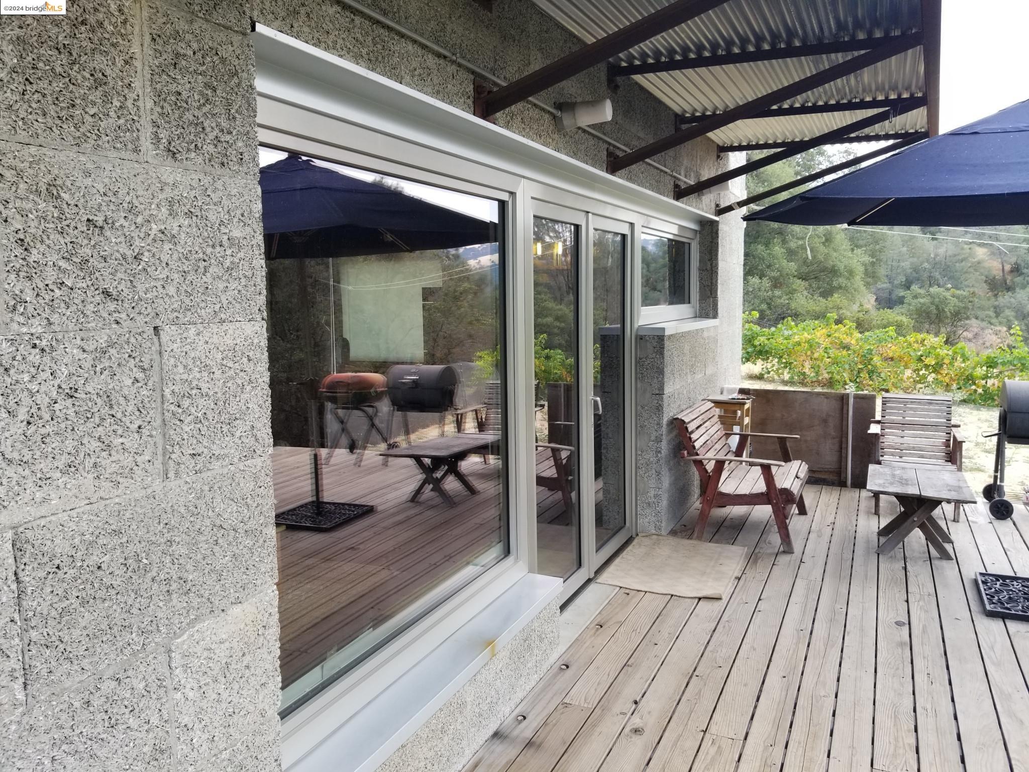 3599 Hector Road Newcastle, CA 95658 - Photo 47 of 51 a view of a patio with table and chairs under an umbrella with wooden floor