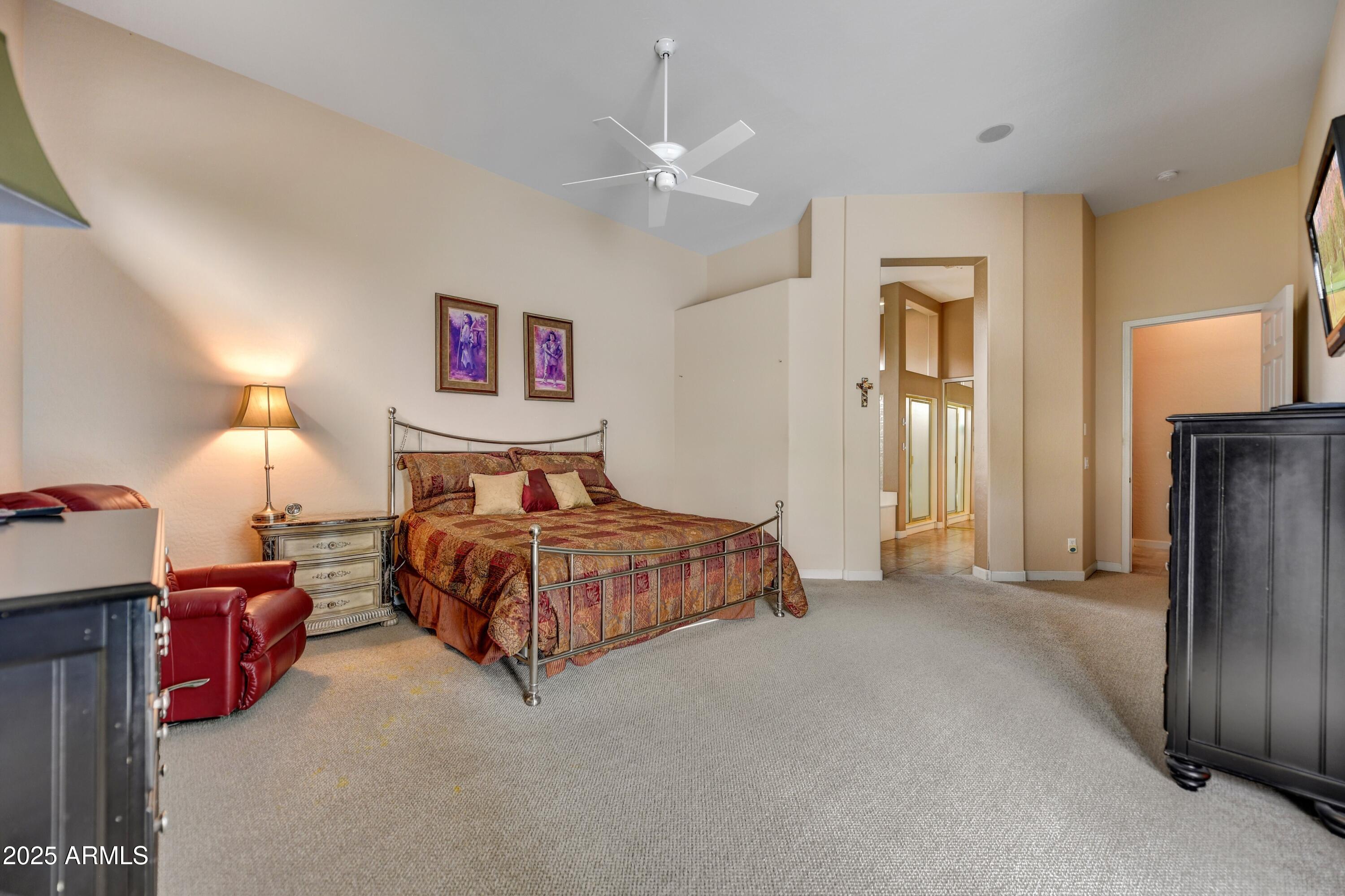 19057 East Alondra Way Rio Verde, AZ 85263 - Photo 11 of 21 a spacious bedroom with a bed and a chandelier