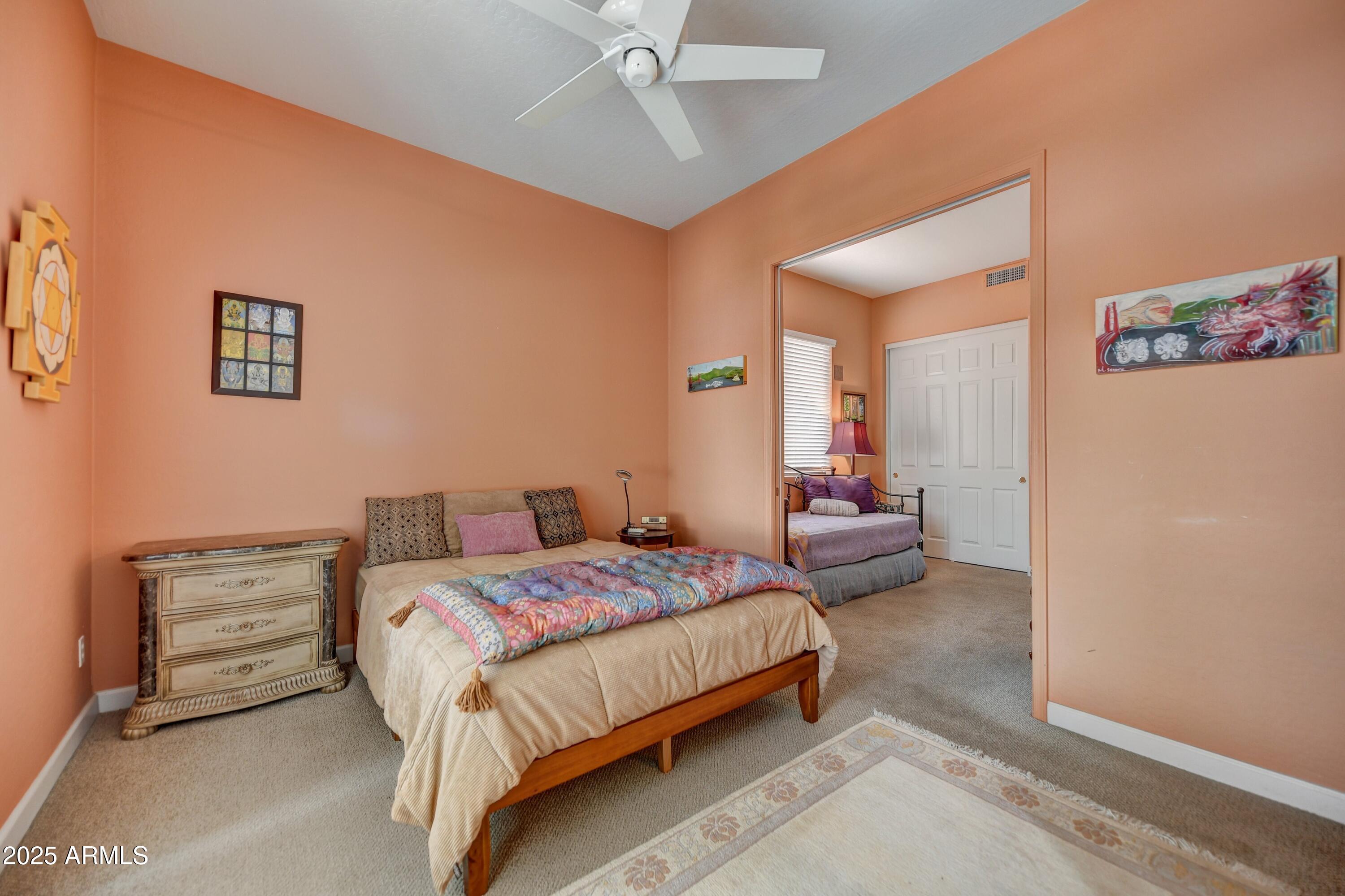 19057 East Alondra Way Rio Verde, AZ 85263 - Photo 16 of 21 a bedroom with a bed and a chandelier