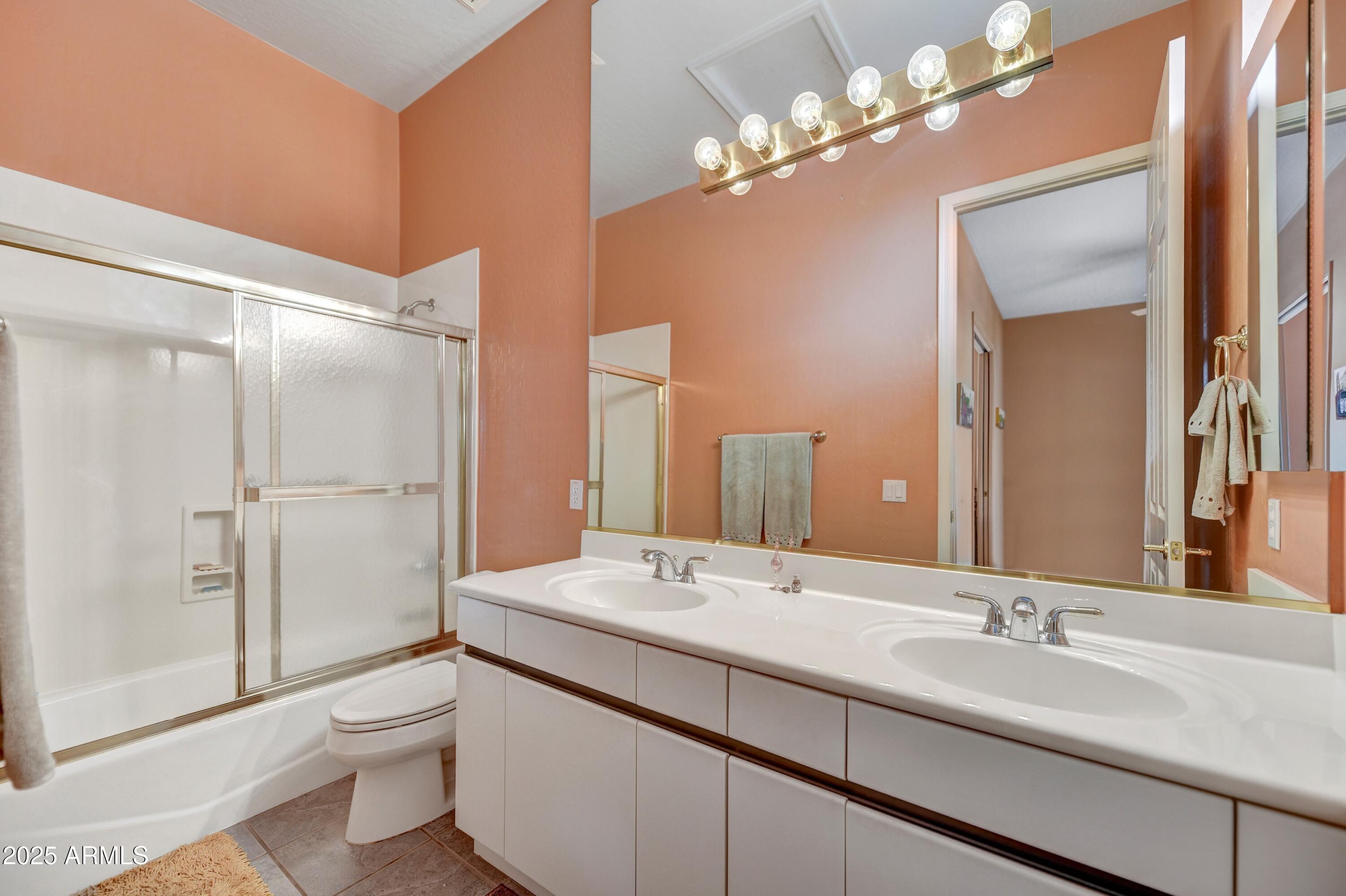 19057 East Alondra Way Rio Verde, AZ 85263 - Photo 17 of 21 a bathroom with a sink a toilet and a large mirror