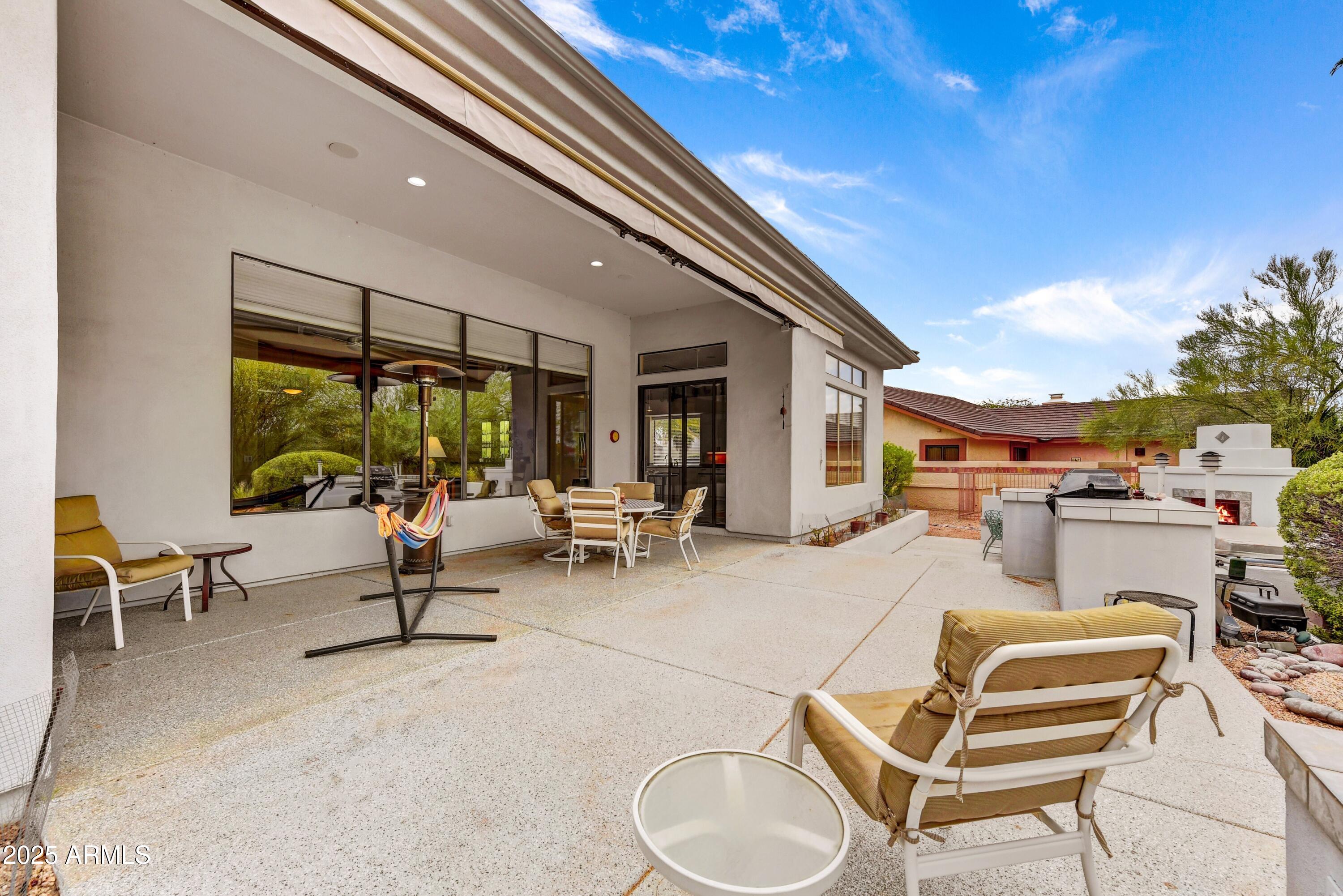 19057 East Alondra Way Rio Verde, AZ 85263 - Photo 18 of 21 a living room with patio furniture and a floor to ceiling window