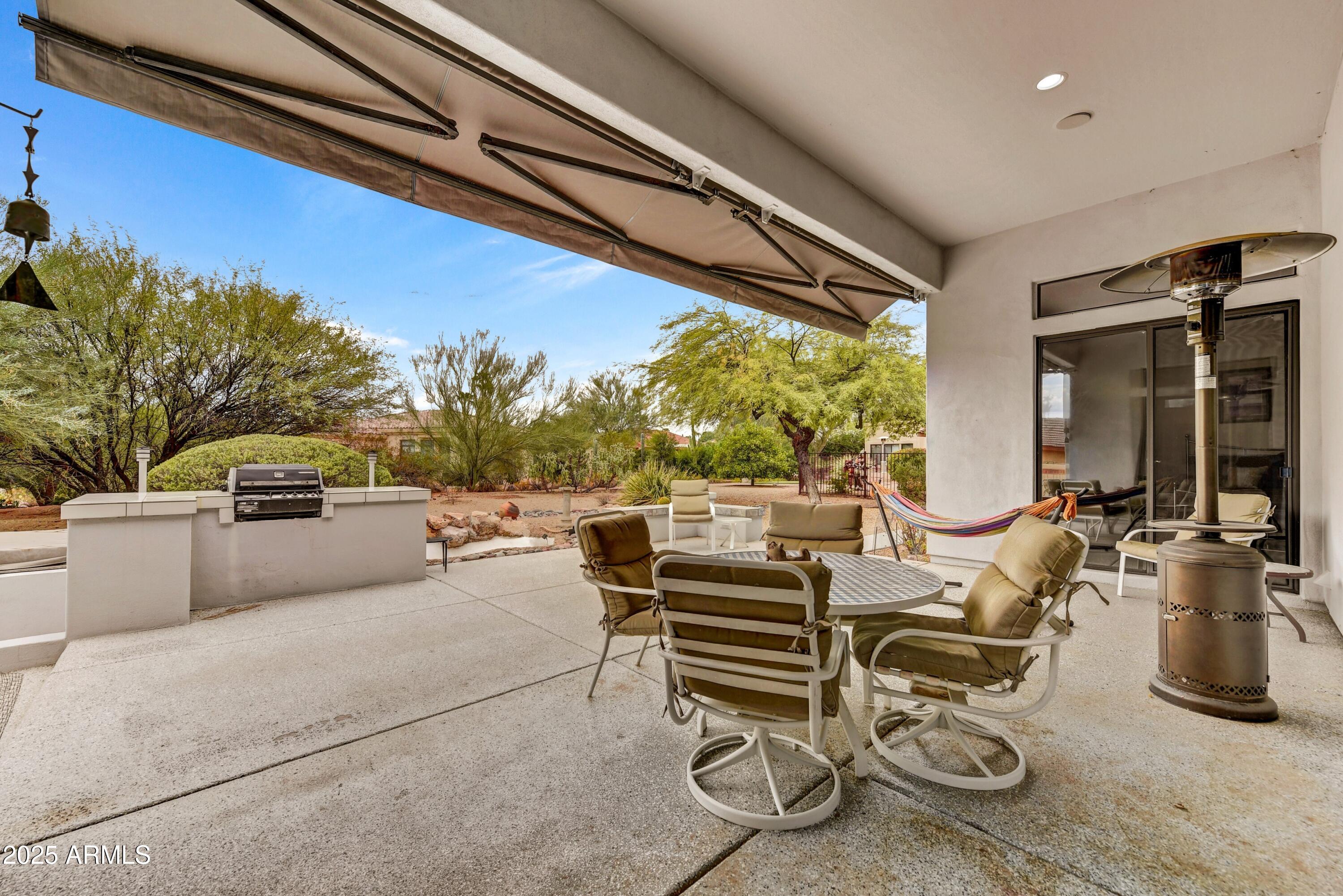 19057 East Alondra Way Rio Verde, AZ 85263 - Photo 19 of 21 a living room with patio furniture and a flat screen tv