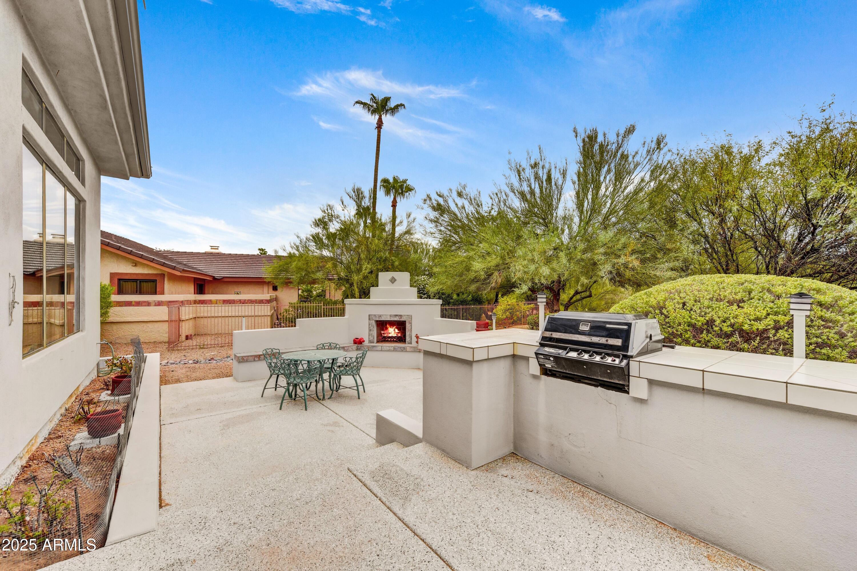 19057 East Alondra Way Rio Verde, AZ 85263 - Photo 20 of 21 a living room with furniture and a flat screen tv