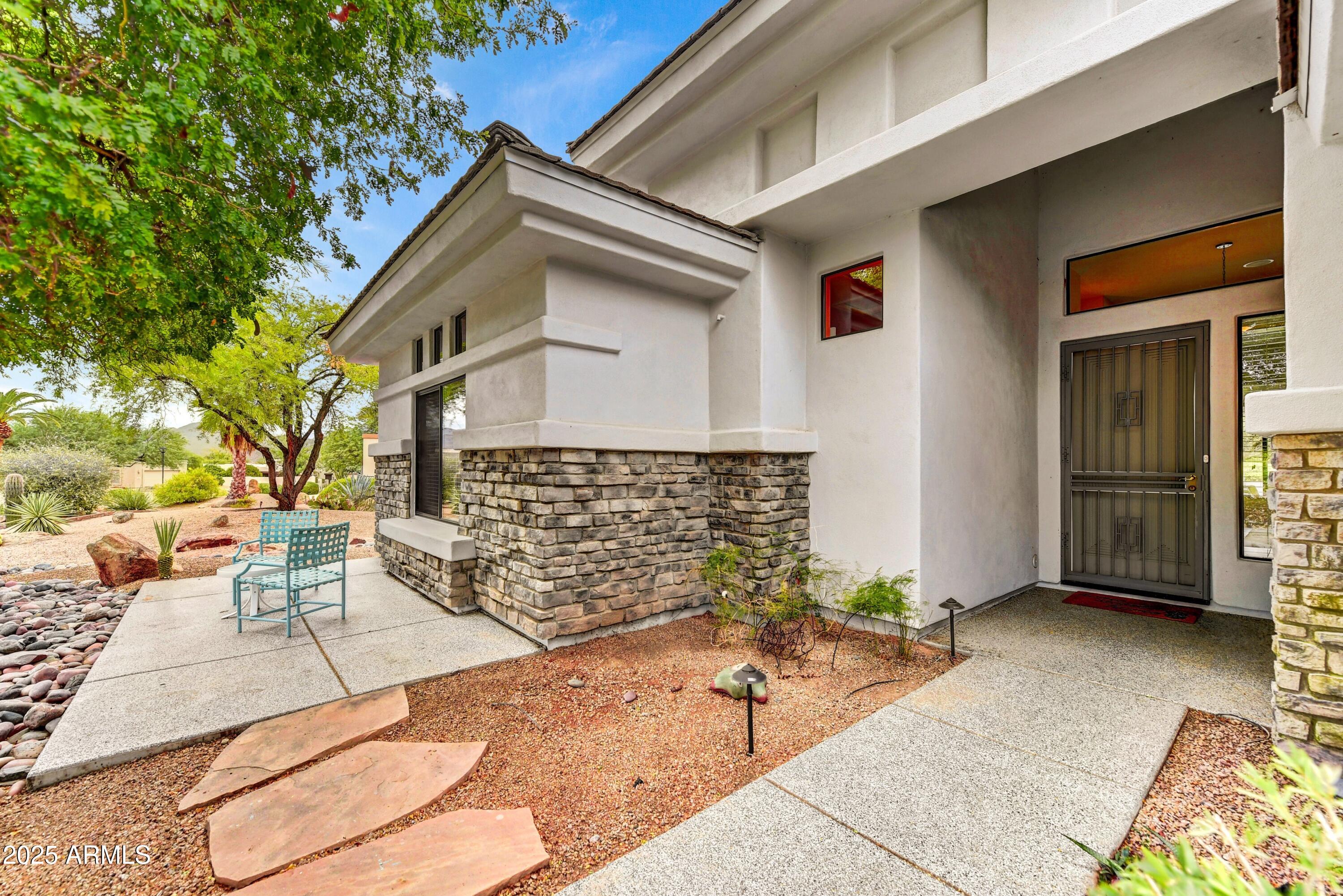 19057 East Alondra Way Rio Verde, AZ 85263 - Photo 2 of 21 a front view of a house with outdoor seating