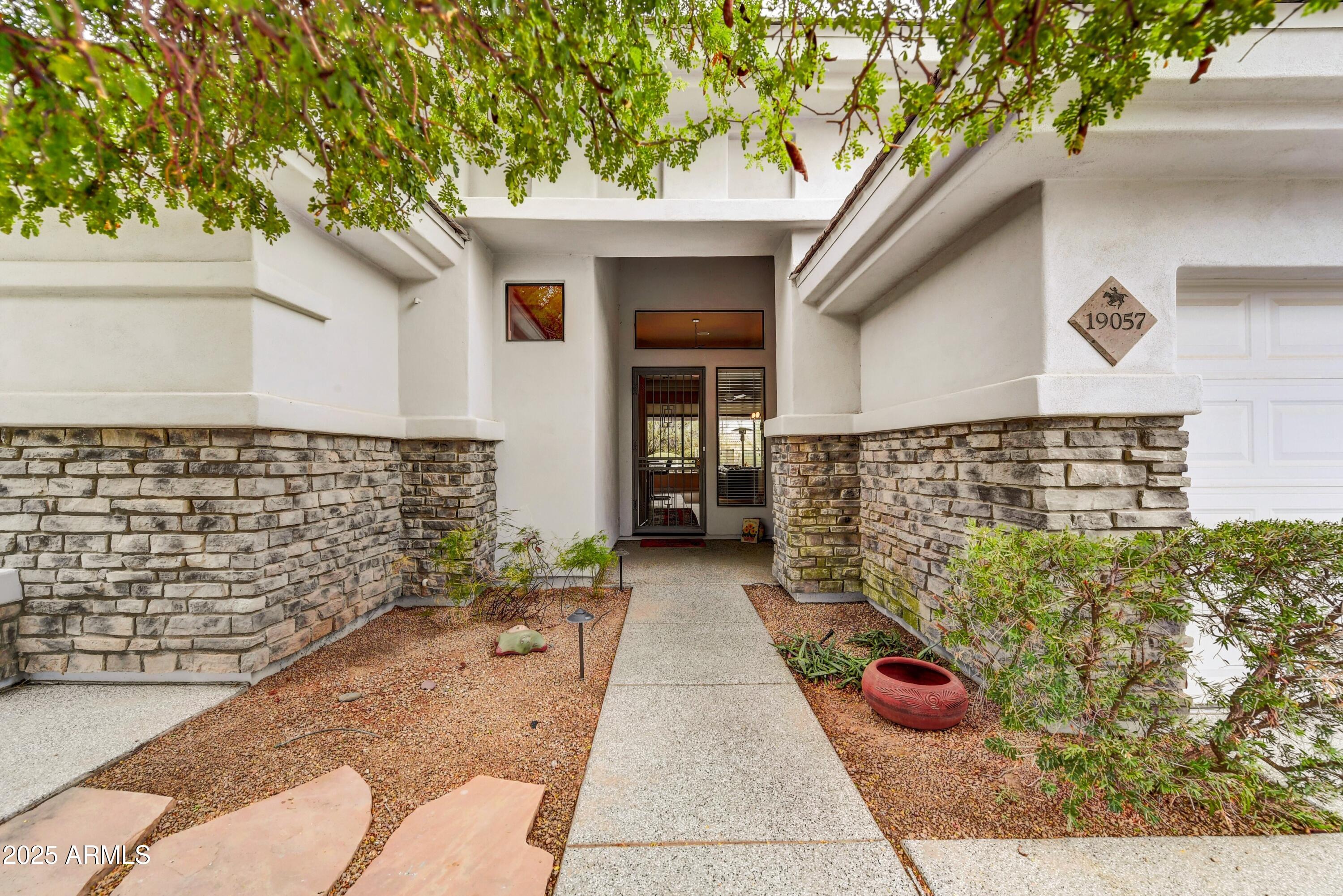 19057 East Alondra Way Rio Verde, AZ 85263 - Photo 3 of 21 a view of front door of house with an outdoor space