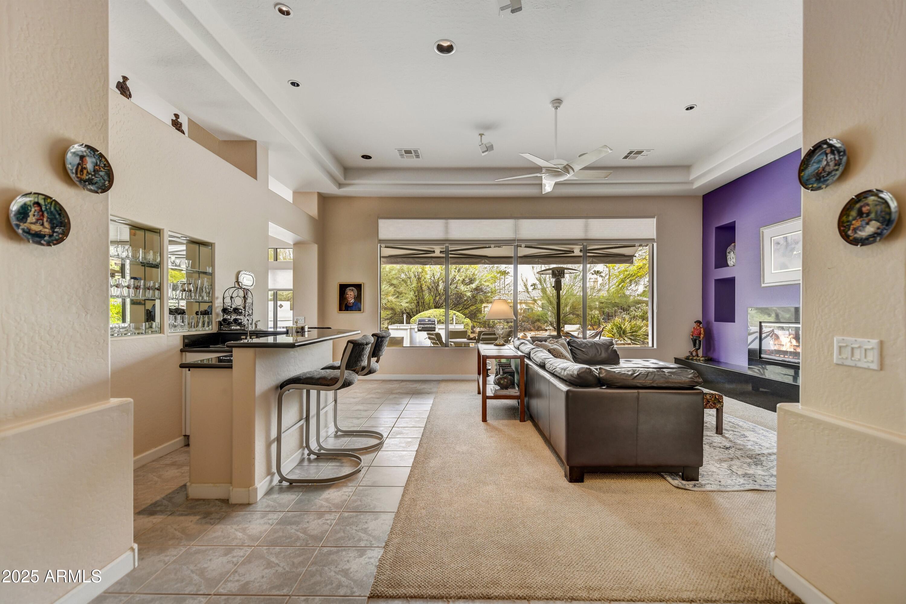 19057 East Alondra Way Rio Verde, AZ 85263 - Photo 4 of 21 a living room with fireplace furniture and a large window