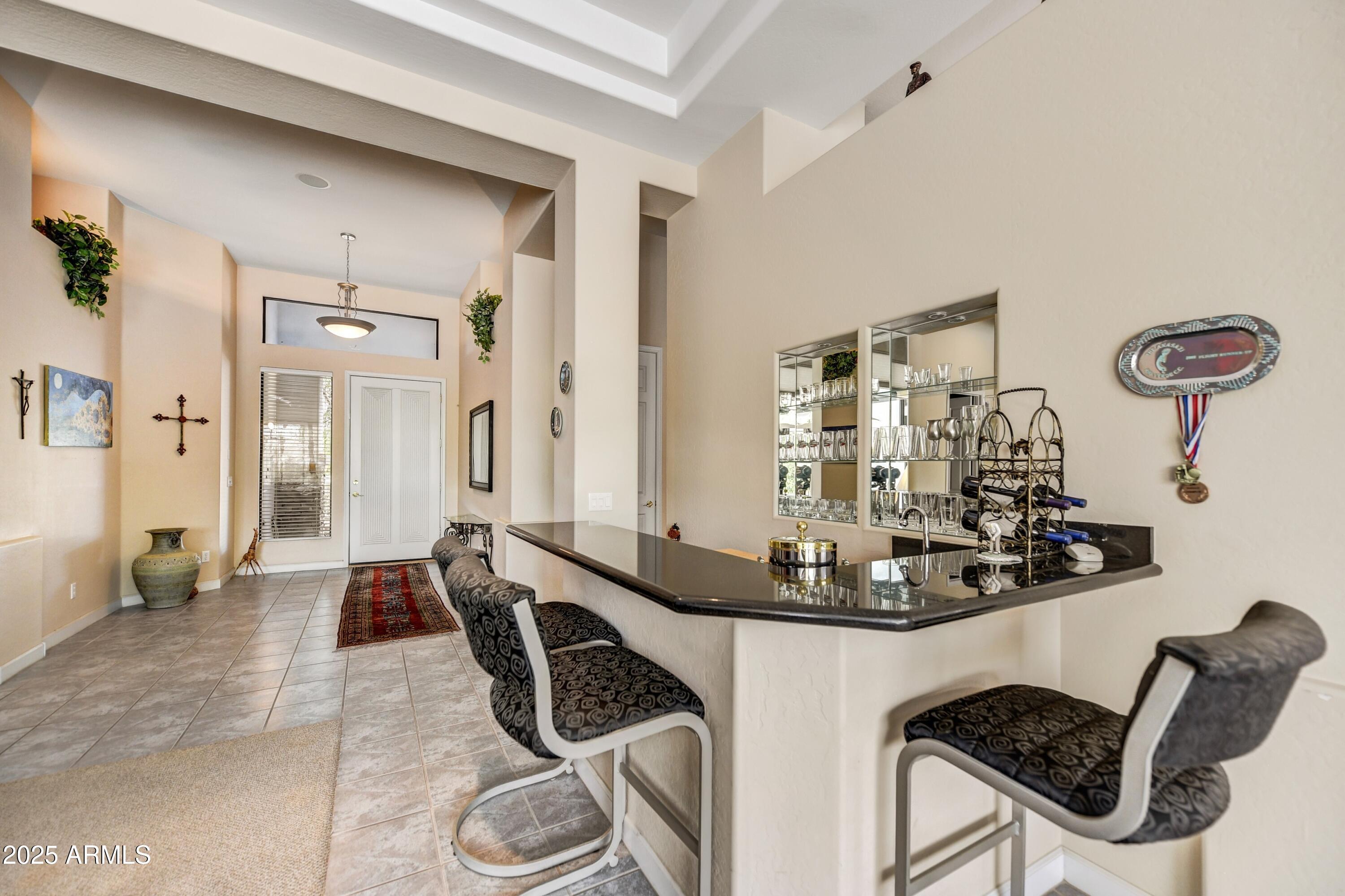 19057 East Alondra Way Rio Verde, AZ 85263 - Photo 6 of 21 a room with two chairs and a wooden floor