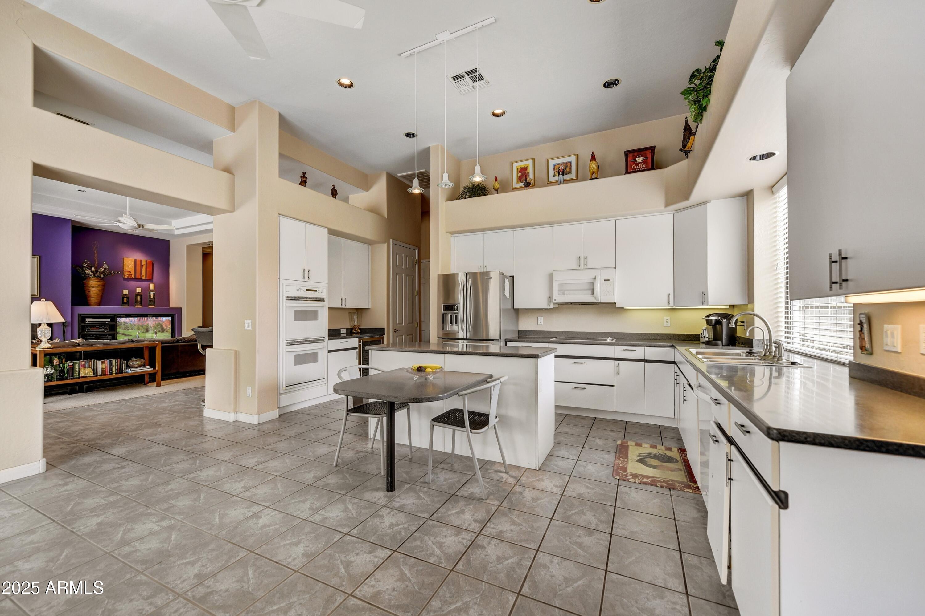 19057 East Alondra Way Rio Verde, AZ 85263 - Photo 7 of 21 a kitchen with cabinets and chairs