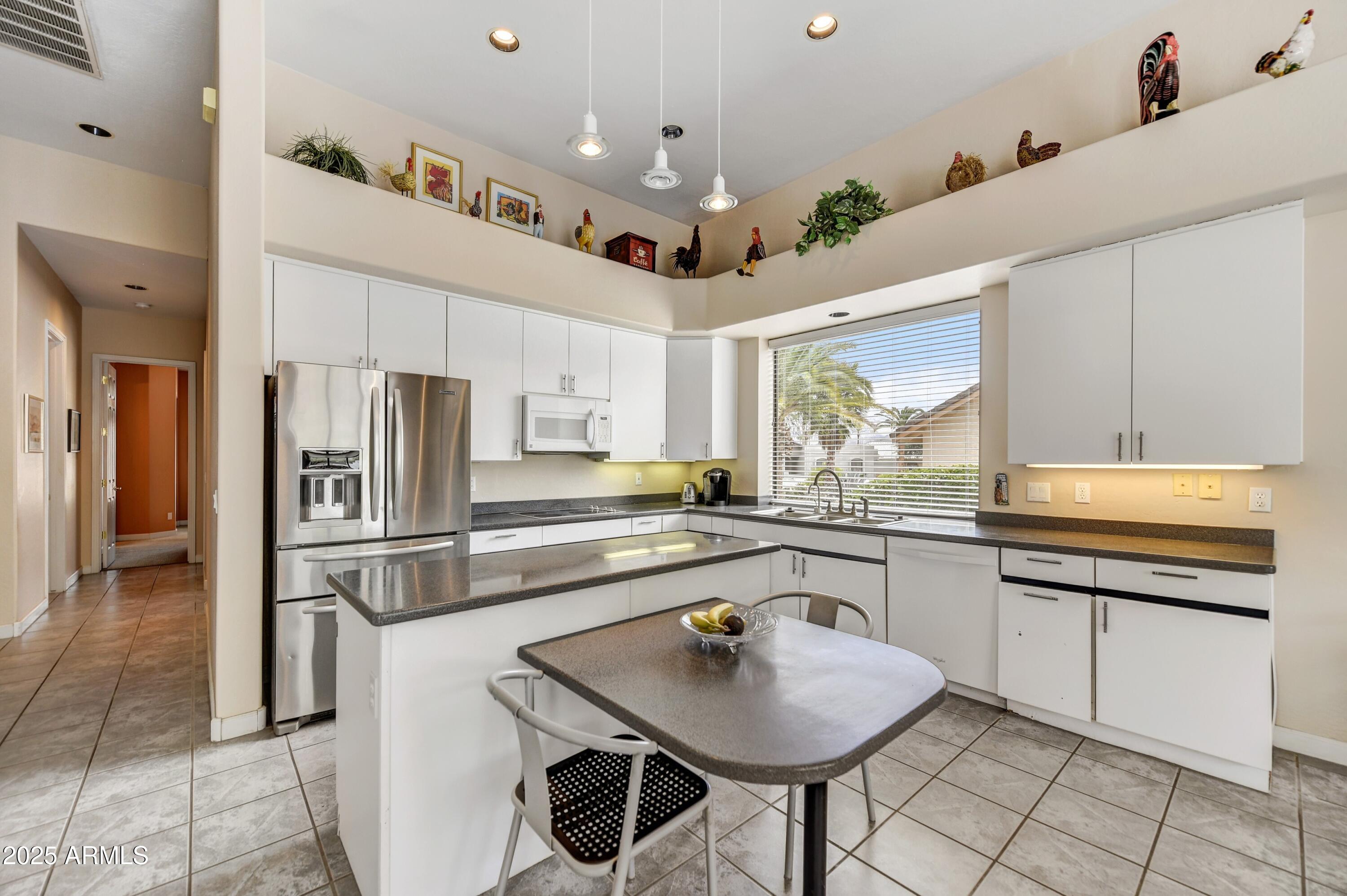 19057 East Alondra Way Rio Verde, AZ 85263 - Photo 8 of 21 a kitchen with stainless steel appliances granite countertop a sink and a refrigerator