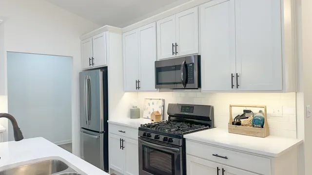 a kitchen with stainless steel appliances a stove microwave and refrigerator