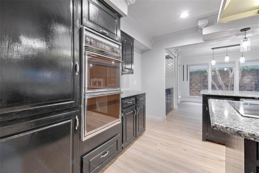 509 North Durango Circle Irving, TX 75062 - Photo 11 of 39 a kitchen with granite countertop stainless steel appliances and wooden floor