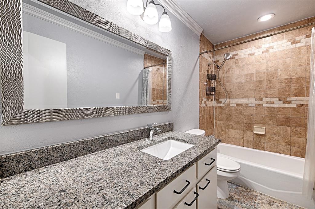 509 North Durango Circle Irving, TX 75062 - Photo 22 of 39 a bathroom with a granite countertop sink toilet and shower
