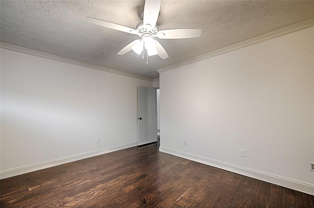 509 North Durango Circle Irving, TX 75062 - Photo 32 of 39 an empty room with wooden floor and fan
