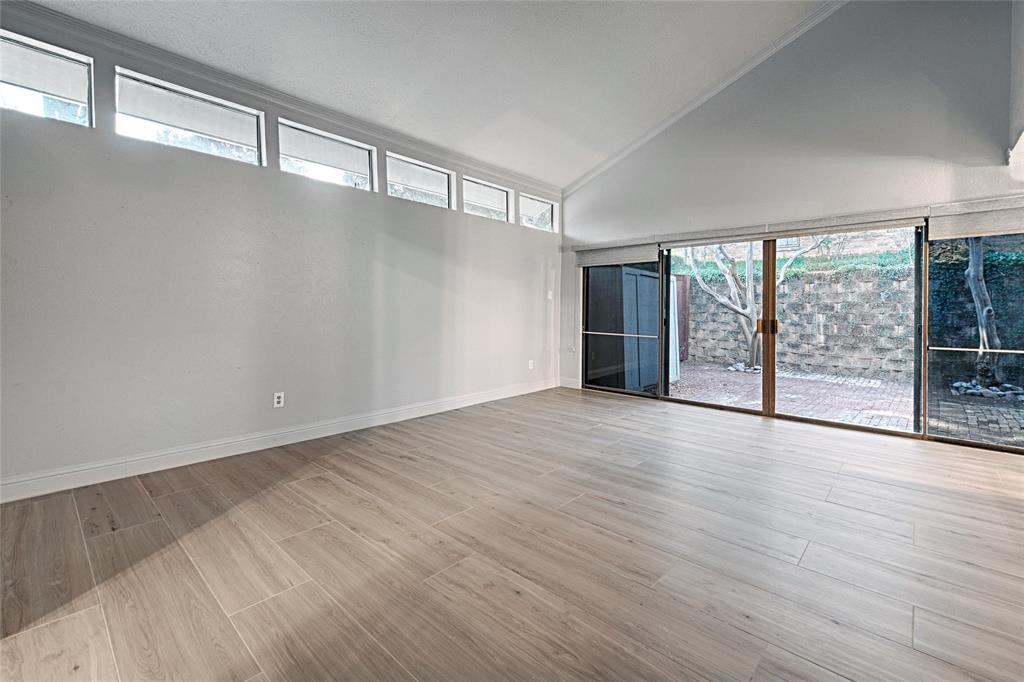 509 North Durango Circle Irving, TX 75062 - Photo 5 of 39 a view of an empty room with wooden floor and a window