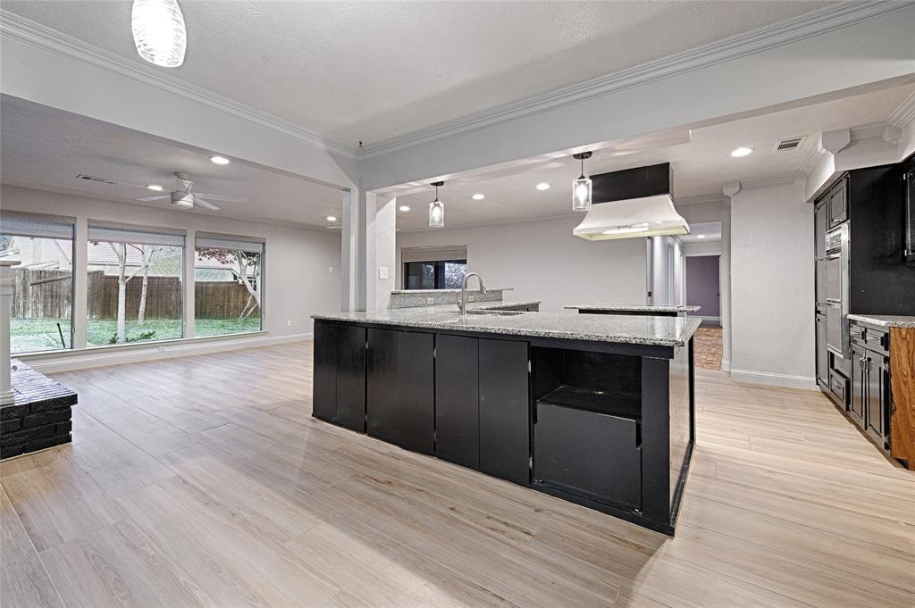 509 North Durango Circle Irving, TX 75062 - Photo 8 of 39 a kitchen with stainless steel appliances granite countertop a large counter top a stove and a wooden floors