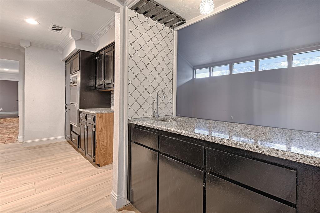 509 North Durango Circle Irving, TX 75062 - Photo 9 of 39 a kitchen with granite countertop a sink and cabinets