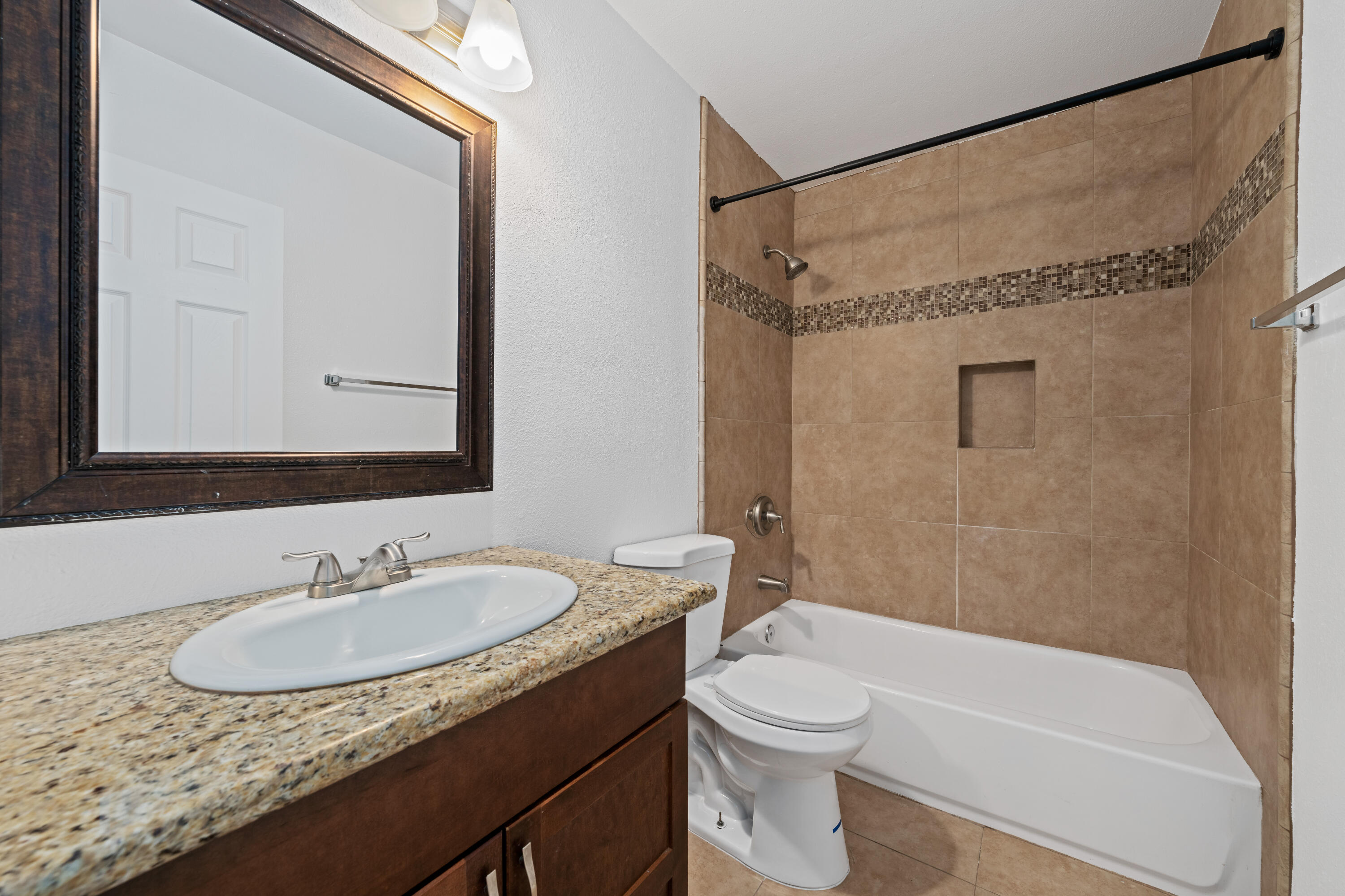 82567 Ave 48, Unit 12 Indio, CA 92201 - Photo 12 of 23 a bathroom with a granite countertop sink toilet and shower