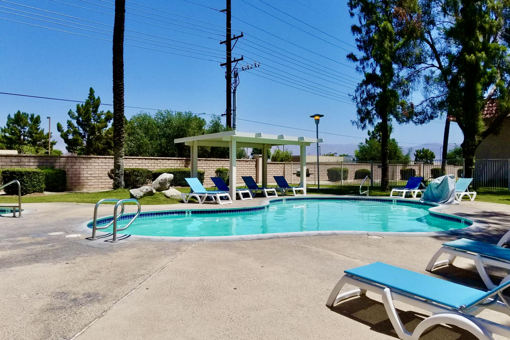 82567 Ave 48, Unit 12 Indio, CA 92201 - Photo 16 of 23 a view of a table and chairs in patio and a yard