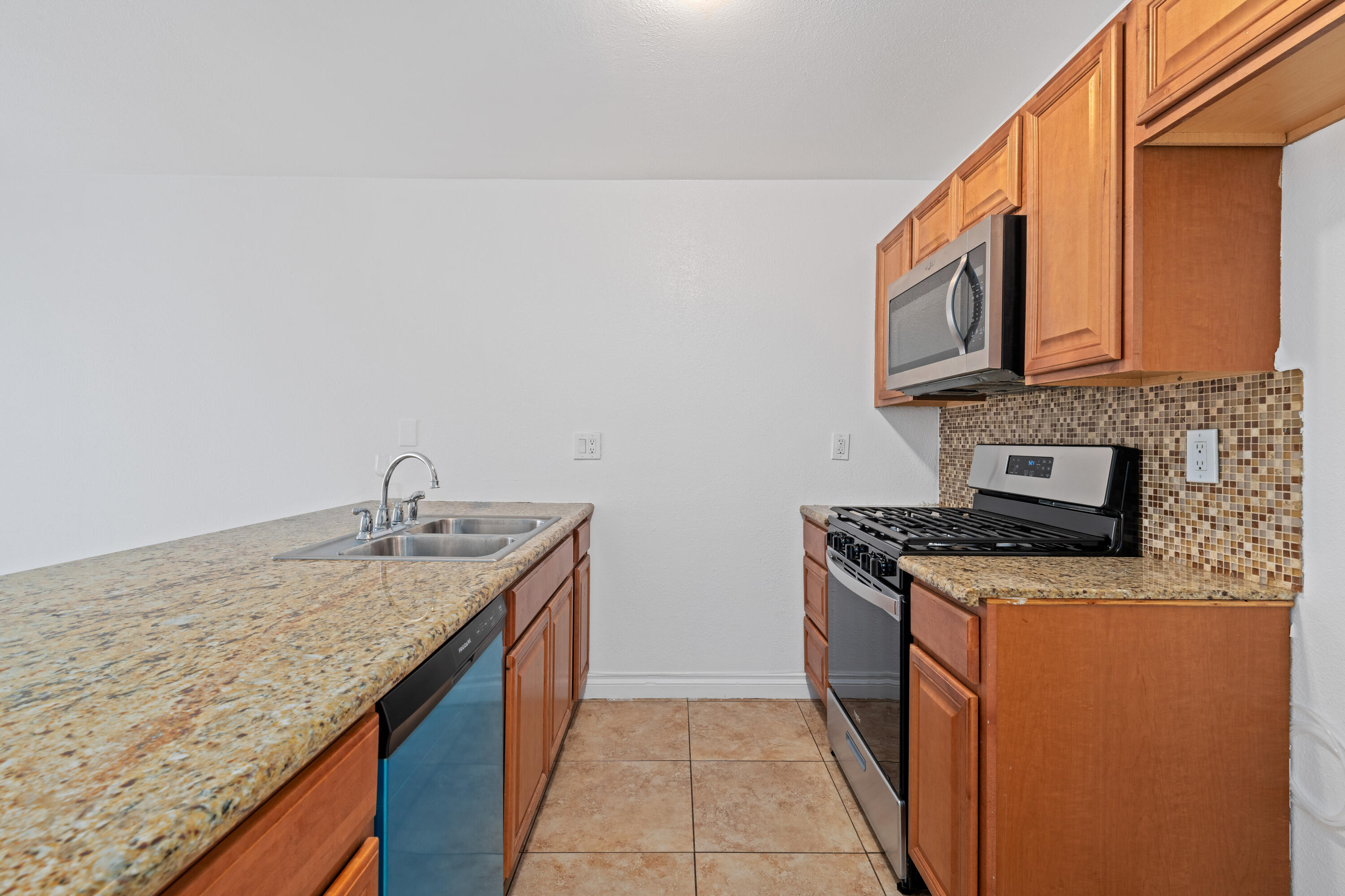 82567 Ave 48, Unit 12 Indio, CA 92201 - Photo 4 of 23 a kitchen with granite countertop a sink stove and cabinets