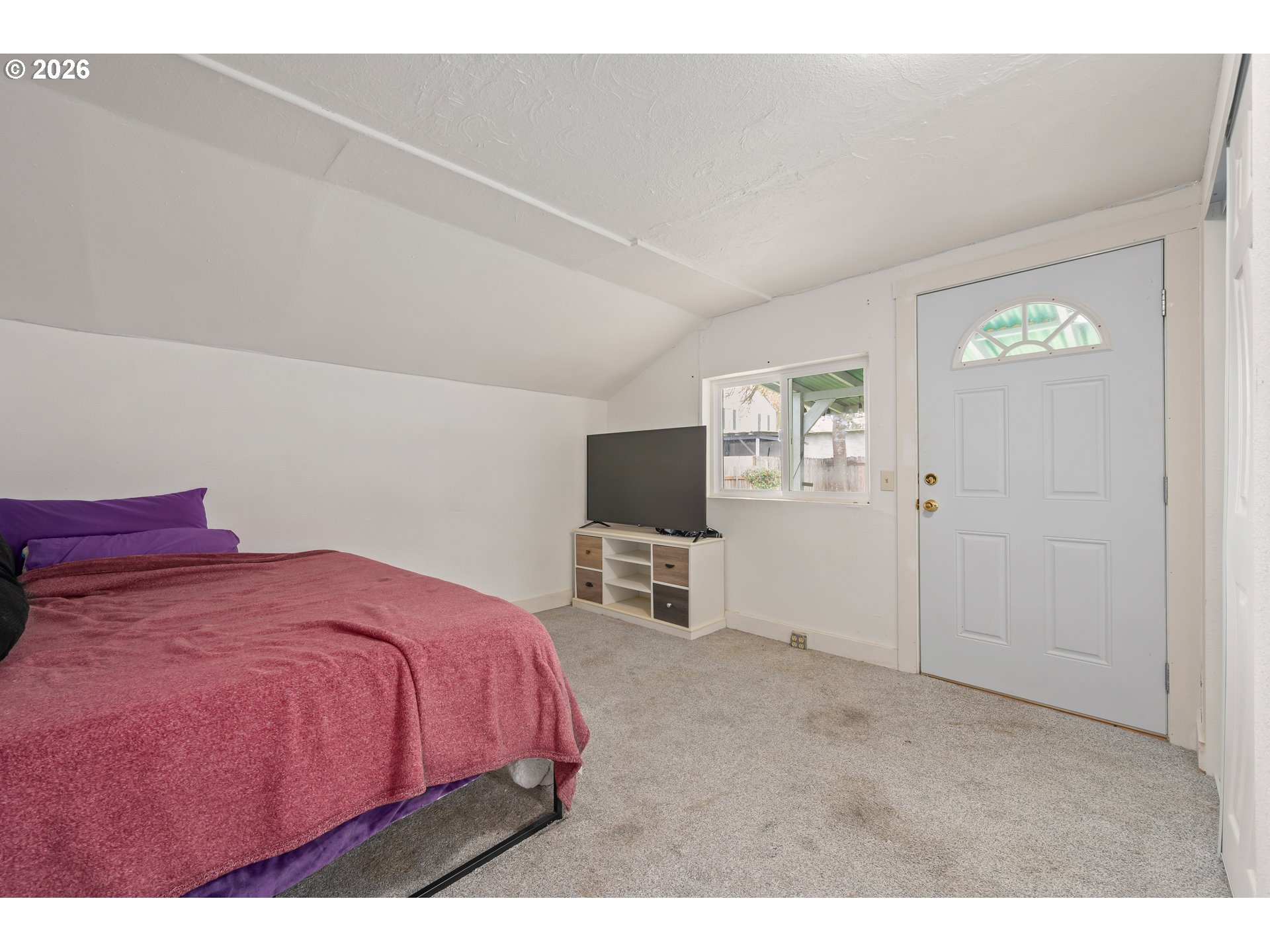 1107 South 7th Street Cottage Grove, OR 97424 - Photo 15 of 34 a bedroom with a bed and a flat screen tv