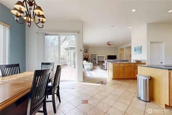 a dining room with furniture a chandelier and window