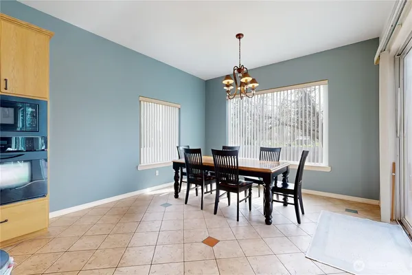 a view of a dining room with furniture and chandelier