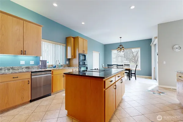 a kitchen with stainless steel appliances granite countertop a sink and cabinets