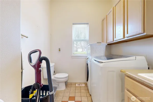 a bathroom with a sink a toilet and a window