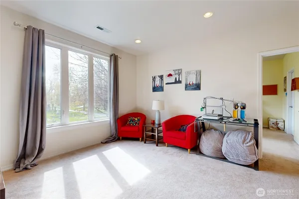 a bedroom with furniture and a large window