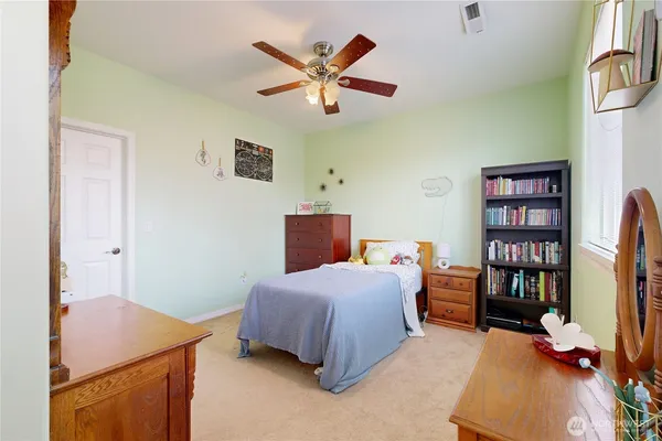 a bedroom with a bed and a book shelf