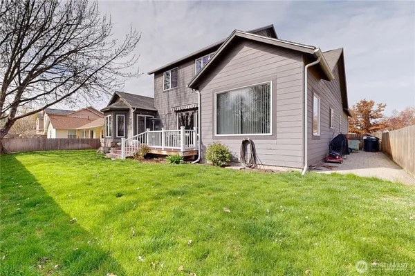 a front view of a house with a garden and yard