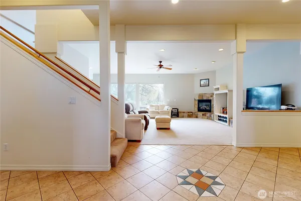 a living room with couches and kitchen view