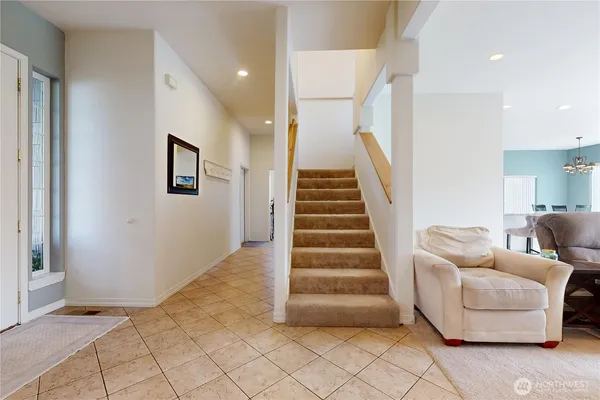 a view of entryway and hall with a couch