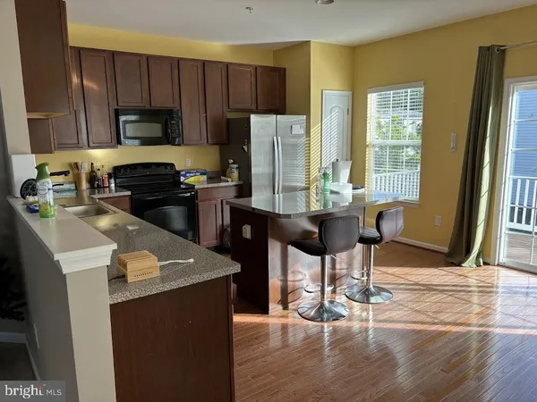 a kitchen with a table chairs refrigerator and cabinets