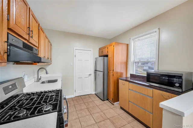 a kitchen with stainless steel appliances a stove a sink and a microwave