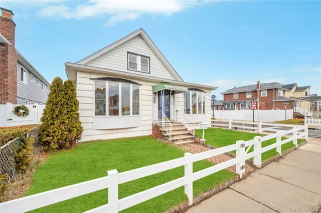 a front view of a house with a yard table and chairs