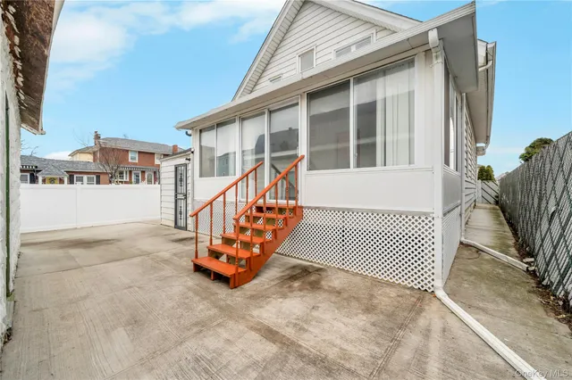 a front view of a house with a yard and fence