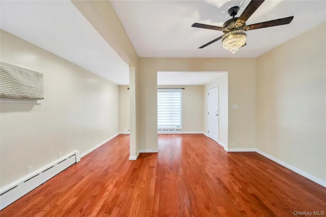 wooden floor in an empty room with a window