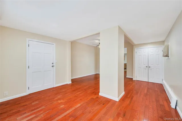 a view of a room with wooden floor