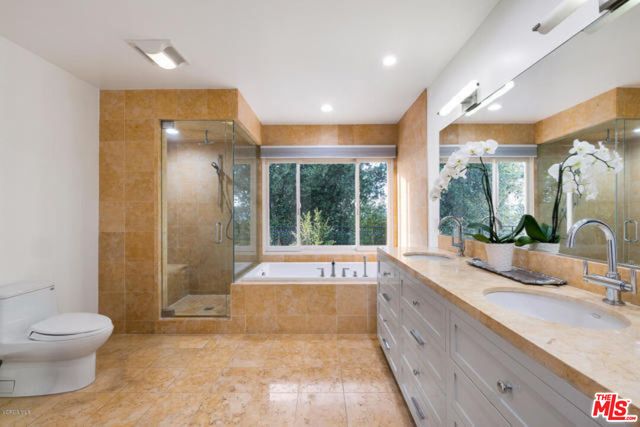 a spacious bathroom with a granite countertop tub sink and mirror