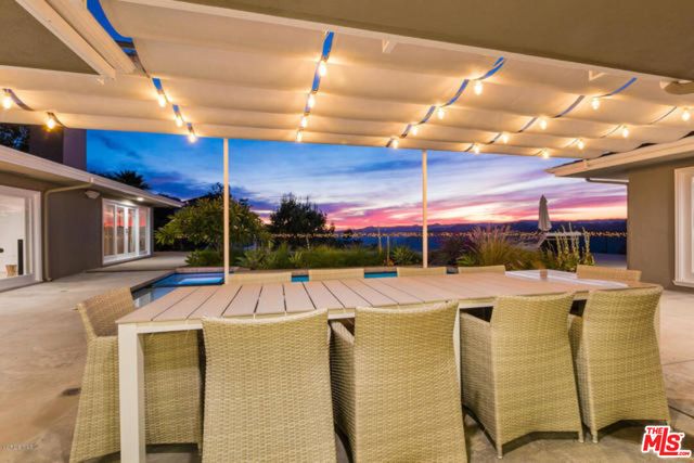 a room with pool table and chairs