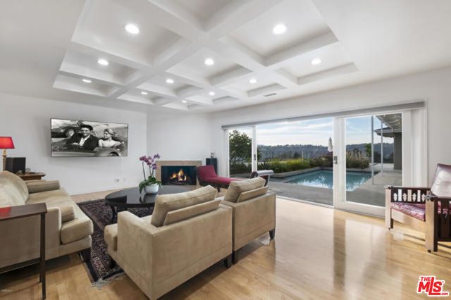 a living room with furniture and a floor to ceiling window
