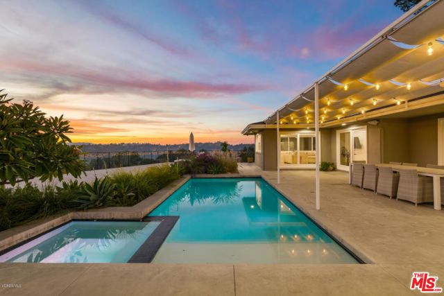 a view of a backyard both side of the house