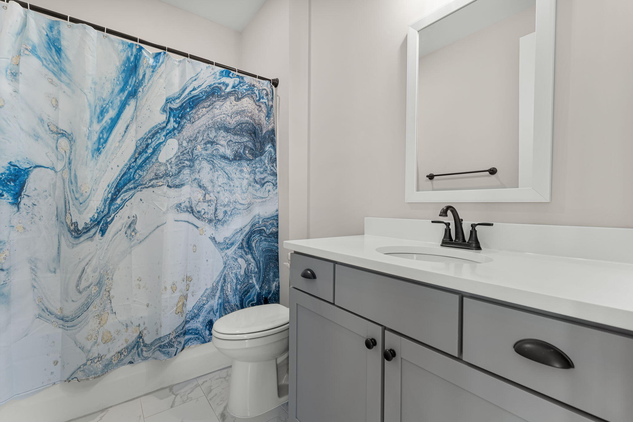1921 Rushes Avenue Panama City, FL 32405 - Photo 12 of 43 a bathroom with a granite countertop sink a toilet and a shower curtain