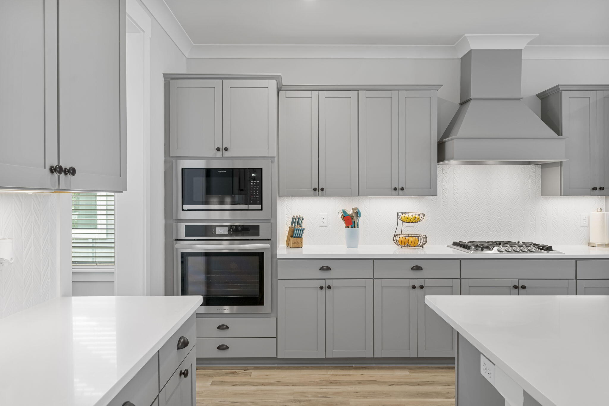1921 Rushes Avenue Panama City, FL 32405 - Photo 13 of 43 a kitchen with stainless steel appliances a stove a sink and white cabinets