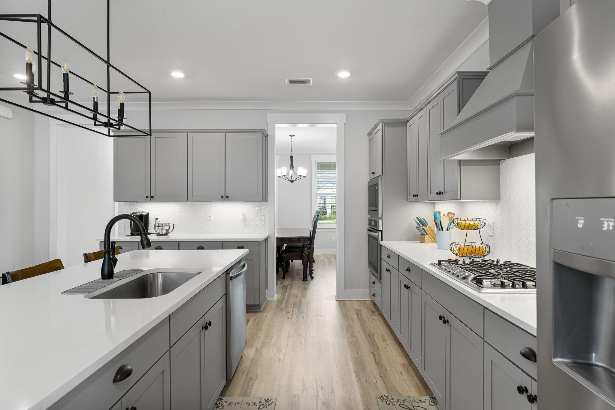 1921 Rushes Avenue Panama City, FL 32405 - Photo 14 of 43 a kitchen with kitchen island a sink stainless steel appliances and cabinets